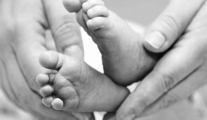 Mother gentle touch - cute baby feet