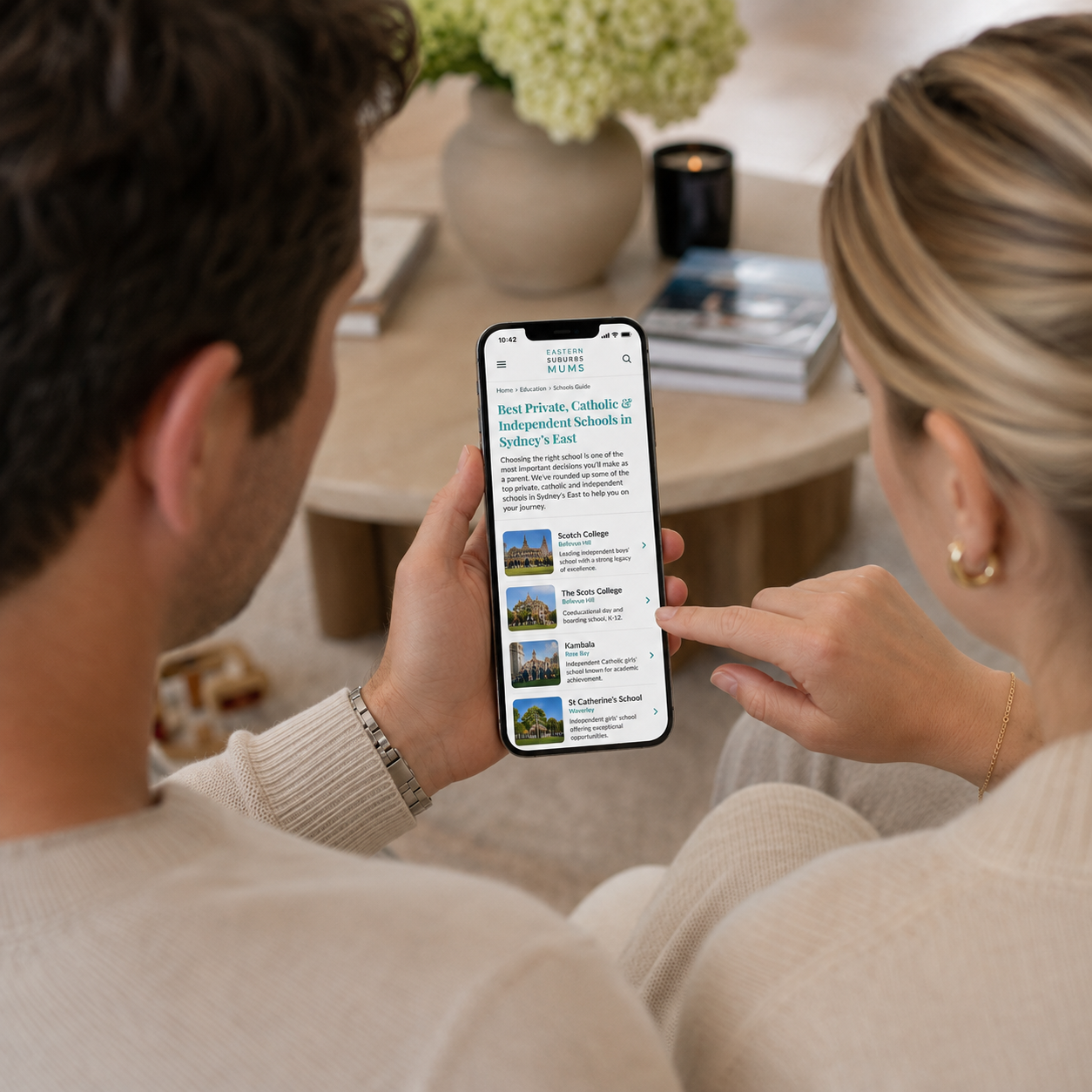 Parents reading an Eastern Suburbs Mums schools guide article on a phone