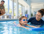 Child learning to swim with an instructor at an Eastern Suburbs swim school